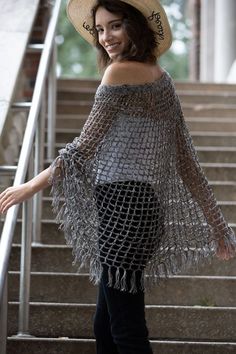 a woman wearing a straw hat standing on some steps