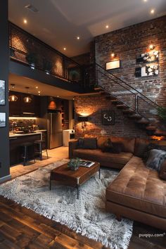 a living room filled with furniture next to a stair case and brick wall behind it