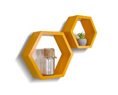 two yellow hexagonal shelves with plants and bottles on them against a white wall