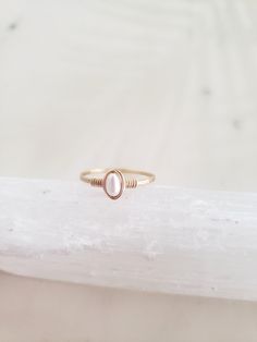 This dainty and feminine freshwater pearl ring is classic, minimal and beautiful! Pairs well with other rings or on its own. Genuine freshwater pearl is lovingly wrapped onto a hand formed and hammered band. The hammering gives lovely shimmery texture and also adds strength to the band! Made from top quality materials - true 14k gold fill or solid sterling silver - will not turn your finger green or wear off. Wear 24/7! Lead and nickel free. Excellent for sensitive skin. Comes packaged in a box Simple Pearl Ring, Pearl Ring Simple, Pearl Stacking Ring, Pearl Ring Gold, White Pearl Ring, Ring Pearl, Simple Hoop Earrings, Gold Pearl Ring, Simple Pearl