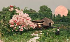 a painting of a woman sitting on a bench in front of a house with pink flowers