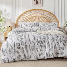 a bamboo headboard and foot board in a room with white walls, bedding and pillows