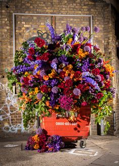 a red wagon filled with lots of colorful flowers