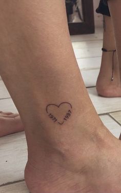 a couple of feet with tattoos on them