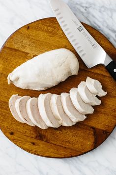 sliced chicken on a cutting board with a knife