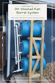 blue barrels are stacked up against the side of a building with text overlay that reads diy stacked rain barrel system