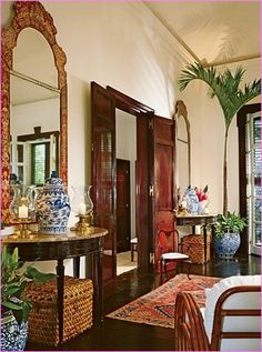 a living room filled with lots of furniture and vases on top of a table