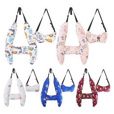 six different styles of baby bibs hanging from hooks