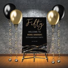 a black and gold birthday party with balloons