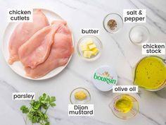 ingredients to make chicken and cheese soup on a white marble counter top, including butter, oil, parsley, garlic, salt, pepper, seasoning, cut up