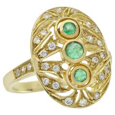 At the heart of this ring lies three mesmerizing round-cut emeralds. Crafted in radiant yellow gold, this vintage-inspired oval filigree ring exudes timeless elegance. The band's shoulders are adorned with diamonds, infusing a touch of luxury. Meticulously placed all over the oval filigree are multiple round small diamonds, enhancing its sparkle and allure. Elevate your hand with a delicate and distinctive ring CHARACTERISTICS Origin: Thailand Metal: Solid 14K Yellow Gold Ring Size: US7 Total Ge Three Stone Ring, Emerald Color, Modern Ring, Filigree Ring, Three Stone Rings, Gorgeous Jewelry, Yellow Gold Ring, Natural Emerald, Emerald Diamond