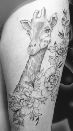 a giraffe with flowers on it's thigh is shown in black and white