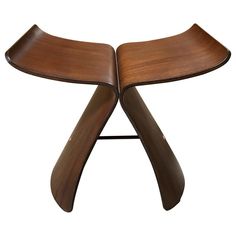 a wooden table with two curved legs