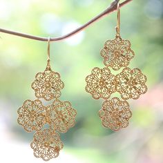 Delicate lace takes the shape of flowers in earrings by Desi Antari. Crafted of sterling silver the dramatic pair is bathed in glowing 18k gold. Gold Flower-shaped Elegant Chandelier Earrings, Gold Flower Chandelier Earrings Elegant Style, Elegant Gold Flower Chandelier Earrings, Gold Filigree Drop Flower Earrings, Gold Flower Jewelry With Intricate Design, Elegant Brass Flower Earrings Nickel Free, Filigree Chandelier Earrings As Gift, Gold Filigree Sterling Silver Chandelier Earrings, Gold Sterling Silver Filigree Chandelier Earrings