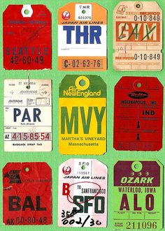 many different colored luggage tags on a green background