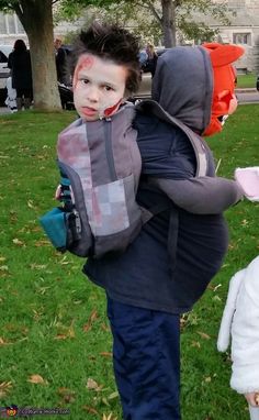 a little boy with his face painted in the shape of a bunny carrying a backpack