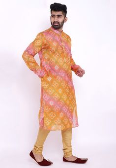 Readymade Art Kota Silk Kurta in Shaded Orange and Pink. This Collar Neck and Full Sleeve attire is Prettified with Buttons and Bandhej Print and has Two Side Pockets. Available with an Art Silk Churidar in Beige.Do note: Footwear shown in the image is for presentation purposes only. Half to one inch may vary in measurement. (Slight variation in actual color vs. image is possible). We sell all kinds of menswear. Mens Kurta | Mens Kurta Pajama | Mens Sherwani | Mens Sherwani Sets | Traditional Me Orange Bandhani Print Sets For Eid, Orange Kurta With Printed Motifs For Festivals, Fitted Orange Bandhani Print Set, Festive Yellow Printed Kurta, Orange Bandhani Print Kurta For Eid, Eid Orange Kurta With Bandhani Print, Orange Bandhani Print Kurta For Diwali, Orange Bandhani Kurta For Eid, Traditional Orange Printed Sets