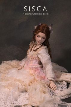 a doll is sitting on the ground wearing a dress with laces and flowers in her hair