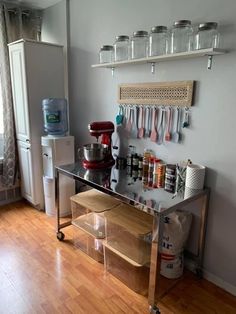 a kitchen area with a counter, refrigerator and shelves