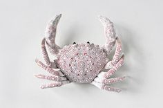 a crab made out of paper with intricate designs