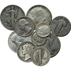 a pile of silver coins sitting on top of each other