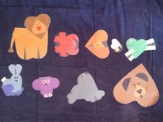 a group of cut out animals sitting on top of a blue cloth covered tablecloth