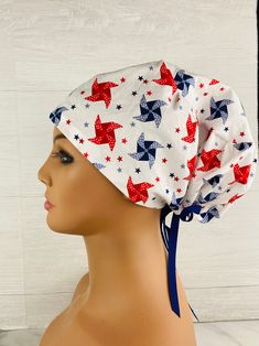 a female mannequin head wearing a white hat with red, white and blue stars on it