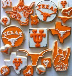 many decorated cookies are arranged in the shape of texas, texas longhorns and texas