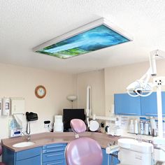 a dentist's office with blue cabinets and purple chairs