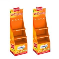 two orange cardboard display stands with food items in each section and one shelf on the other side