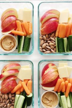 four glass containers filled with different types of food and nuts on top of each other