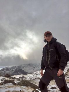 a man standing on top of a snow covered slope