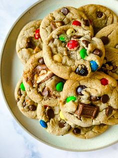 a white plate topped with cookies and m & m's on top of a table