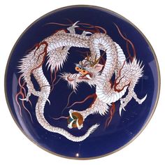 a blue plate with two dragon on it