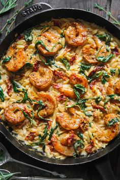 pasta with shrimp and spinach in a skillet