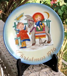 a plate with two children on it sitting on a table in front of some trees