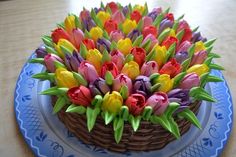 a cake decorated with colorful tulips on a blue plate