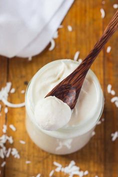 a wooden spoon in a glass jar filled with whipped cream