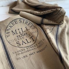 an image of a scarf that is on top of a bedding set with the words yankee street mill and course grand salt printed on it