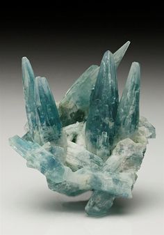 An unusual cluster of spire-like crystals of gemmy blue to opaque white Aquamarine measuring to 4.3cm tall from the Mimoso do Sul mine, Espírito Santo, Brazil. Handmade Crystal Jewelry, Metamorphic Rocks, Pretty Rocks, Crystal Magic, Crystal Jewellery