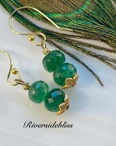 Grade AAA faceted Emerald Beaded Earrings! I accented these with tiny faceted gold brass ball beads and gold leaf shaped bead caps. They have 18k gold plated ear wires! Lovely green and a very nice sparkle! May Birthstone is Emerald please check measurements, as it can be difficult to determine the exact size from the photos!  MEASUREMENTS :  Earrings: 1 1/2" long including ear wires!  Faceted emerald beads: 8mm This is the exact pair of earrings that you will receive in the photos!! Pink Opal Earrings, Emerald Bead, Birthstone Earring, Emerald Earrings, Brass Accents, Opal Earrings, Christmas Earrings, Gold Brass, Pink Opal