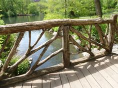 a wooden bridge over a river surrounded by trees