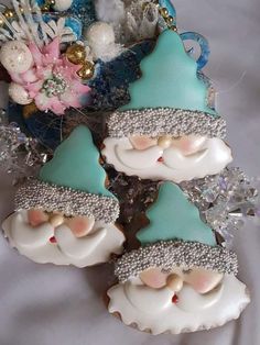 three decorated cookies sitting on top of a table