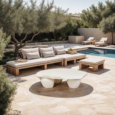 an outdoor seating area next to a swimming pool