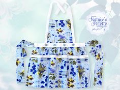 the apron is blue with yellow flowers on it and has two ties at the waist