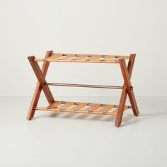 a wooden rack with two shelves on each side