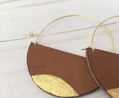 A lot of love and attention to detail went into these brown circle leather statement earrings. Leather pieces were cut into the half moon shape. Each moon was then given a tiny touch of gold paint on the bottom. The edges of the crescents were then burned to give them a darkened, rustic appearance. The ear wires were cut to length and formed into the curved shape. The ear wires are made from jeweler's bronze. These earrings measure approximately 2 5/16 x 3 inches. Thanks for checking out my earr Nickel-free Brown Circular Earrings, Modern Small Hoop Brown Earrings, Modern Brown Small Hoop Earrings, Monarch Jewelry, Large Gold Earrings, Rustic Earrings, Painted Earrings, Moon Shape, Half Circle