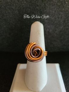 Hello & Welcome! In this listing you will find a very pretty, handcrafted aluminum wire wrapped ring. Size 8 Made using 16 gauge brown & orange aluminum wire & lot's of love. It is non-adjustable & is true to size. You will receive the exact ring that is shown in the photos. Free gift wrapping is available. If you're sending the ring as a gift, please mark the gift option or leave me a note in the "notes" section during checkout. If you have any questions, feel free to send me a message & I'll be happy to assist you. Thanks for taking a look & have yourself a beautiful day!♥ Hand Wrapped Spiral Rings As Gift, Unique Wire Wrapped Rings For Anniversary, Modern Twist Wire Wrapped Rings As Gift, Adjustable Spiral Hand Wrapped Rings, Wire Wrap Ring For Men, Copper Wire Wrapped Rings As Gift, Adjustable Copper Wire Wrapped Rings, Men’s Wire Wrapped Ring, Wire Wrapped Rings Intricate