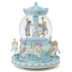 a snow globe with horses in it on a white background and blue trimmings