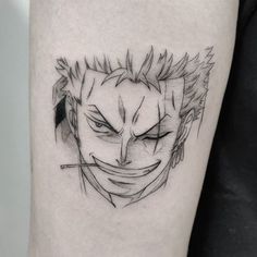 a black and white photo of a joker tattoo on the leg with an evil face